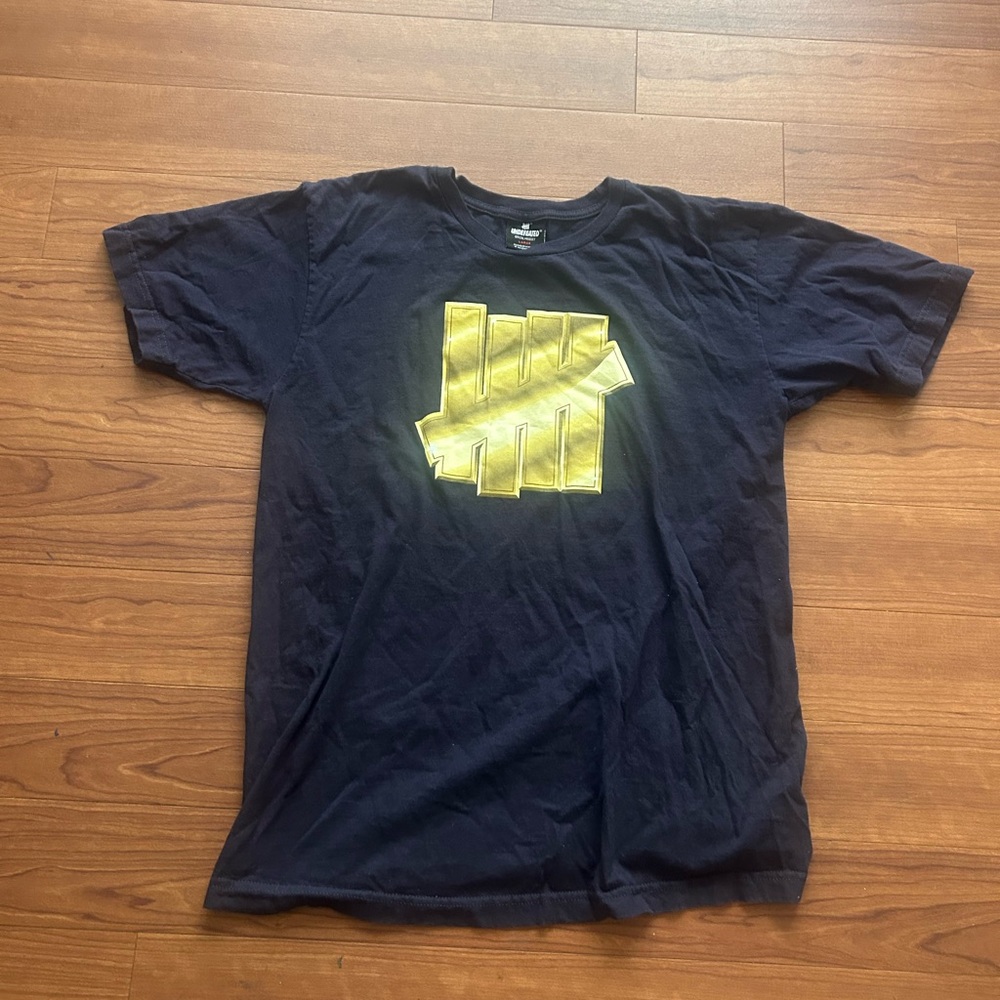 Undefeated Dark Blue Tee with Bold Yellow Graphic